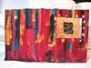 Four-hole stab bound book made of watercolor paper and acrylics with a window.